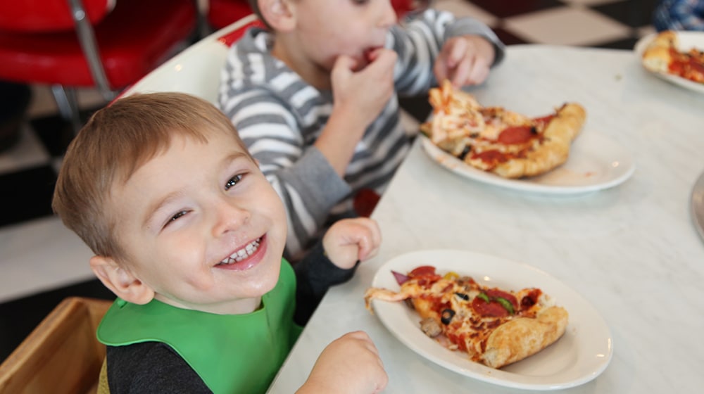 frostys-fun-center-kid-smiling-pizza-fall-homepage-2019