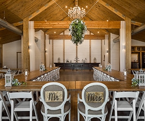 Inside of Matilda's Event Barn set up for wedding with Mr. and Mrs. chairs