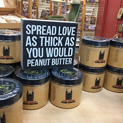 Jars of Peanut Brother peanut butter and black and white sign at Saint Meinrad Archabbey