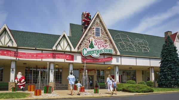 Exterior of Santa Claus Christmas Store with a mom, dad, and children walking up to the entrance