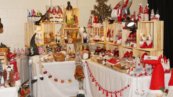 Tables set up at the Santa Claus Arts & Craft Show display Christmas-themed crafts